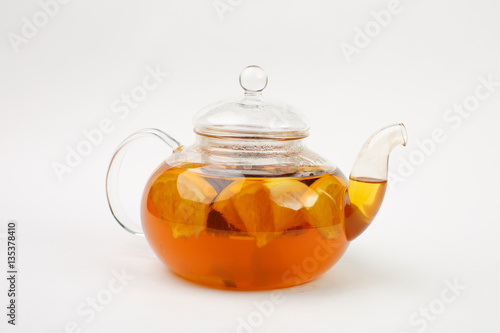 Beautiful tea in a transparent teapot on a white background