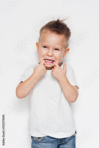 Cute young boy making a funny face against a white background 