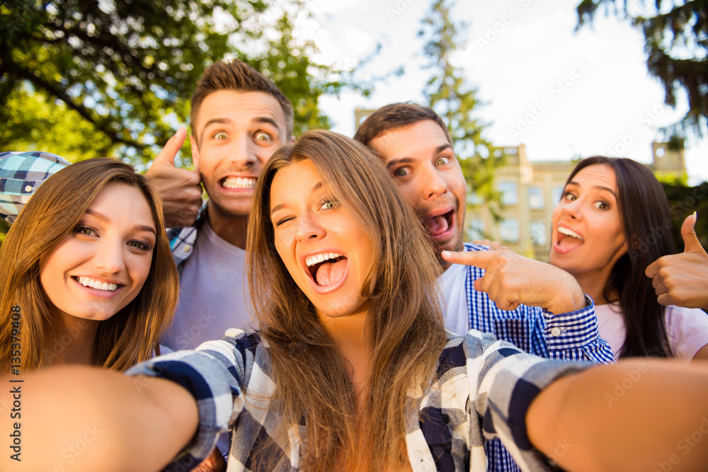 Selfie of five happy comic friends with beaming smiles Selfie of five happy comic friends with beaming smiles