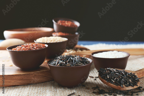 Different types of rice in small bowls closeup © Africa Studio