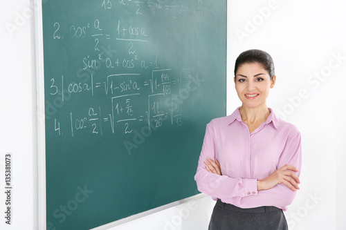 Young female teacher beside...