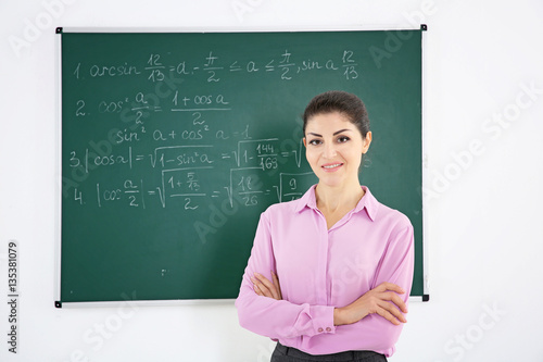 Young female teacher beside...