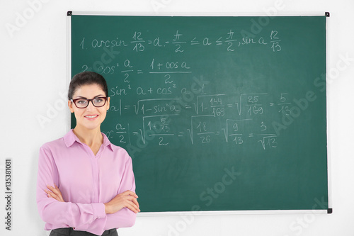 Young female teacher beside...
