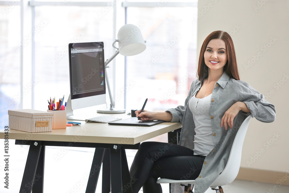 Young female designer working in office Young female designer working in office
