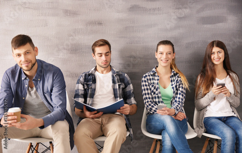 Group of young people waiti...