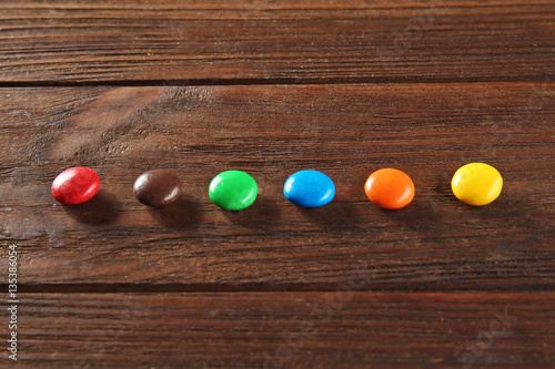 Colorful candies on wooden background