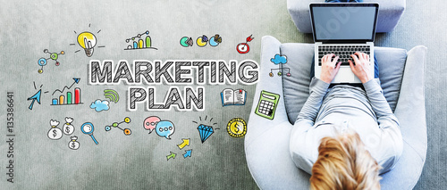 Marketing Plan text with man using a laptop