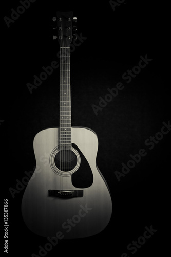 Acoustic guitar on a black background with copy space,black and white 