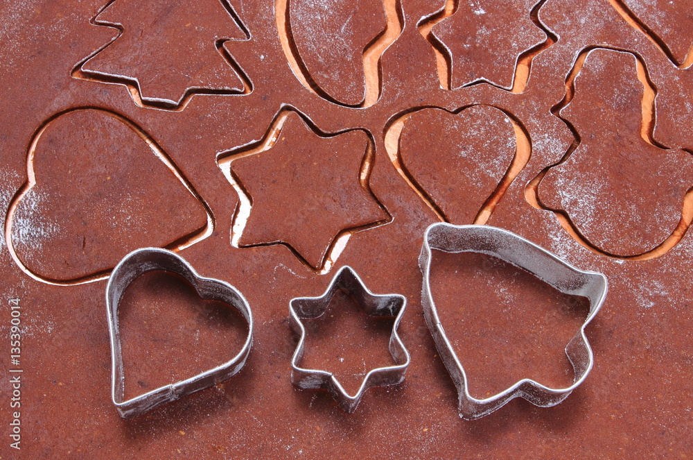 Metal cookie cutters and dough for gingerbread