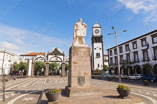 Main square of Ponta Delgada with statue of Gonzalo Velho Cabral in Azores. Portas da Cidade Gates and Saint Sabastian church with clock tower located there. photo