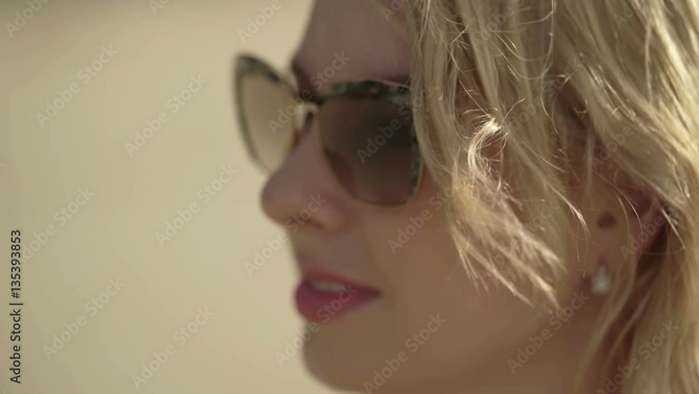 Young sexy blonde woman in bikini on the beach closeup Young sexy blonde woman in bikini on the beach closeup