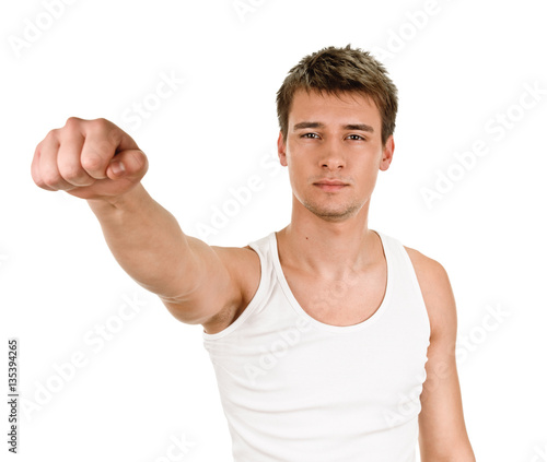 young man kicks clenched fist arm