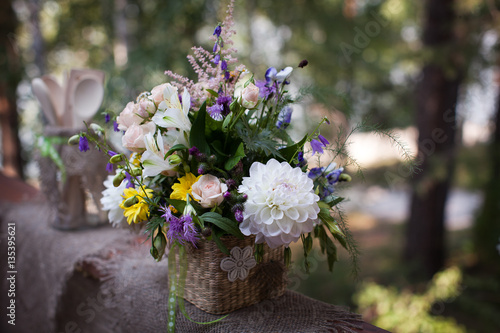 Fototapeta Naklejka Na Ścianę i Meble -  Wildflowers in a basket with blured background