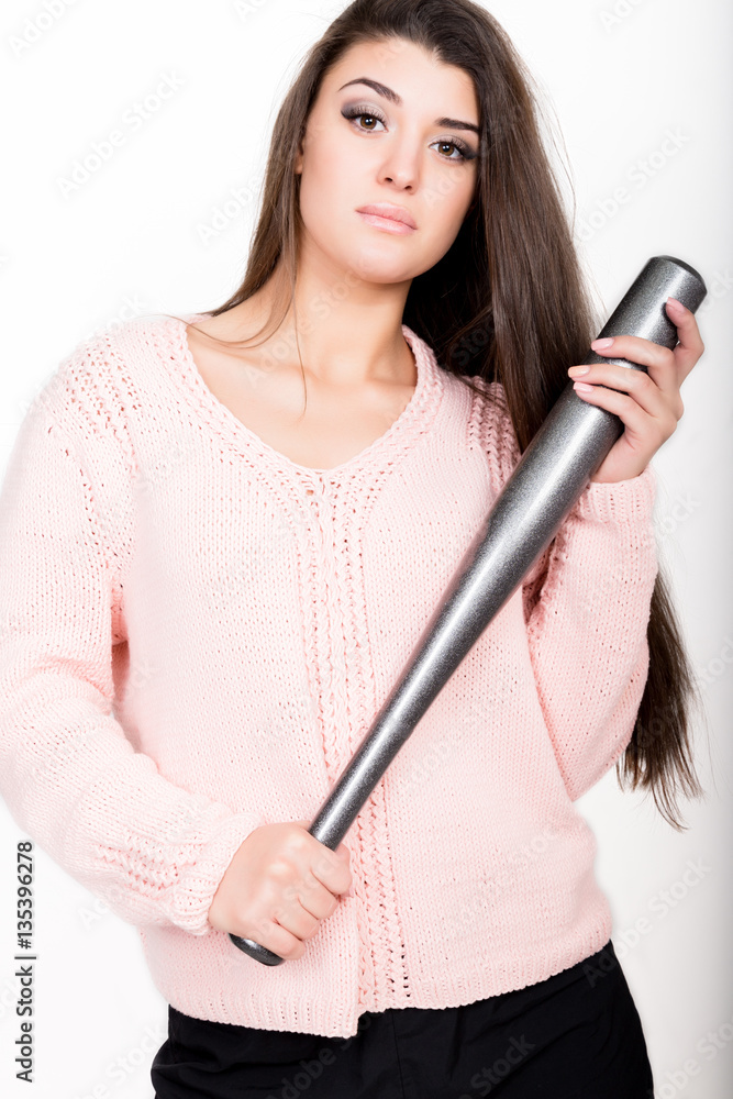 Fototapeta premium nice woman in a knitted sweater holding baseball bat