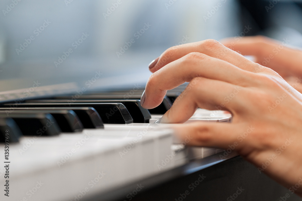Closeup of hands playing piano. Music and hobby concept Closeup of hands playing piano. Music and hobby concept