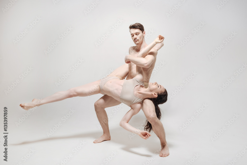 Flexible young dancers training in the white room Flexible young dancers training in the white room