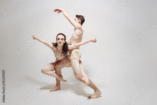 Inventive young dancers performing in the white colored studio