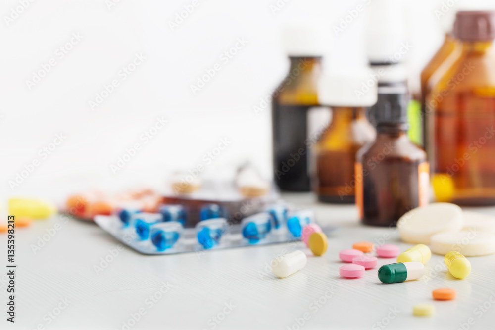 Composition of medicine bottles and pills on white background Composition of medicine bottles and pills on white background