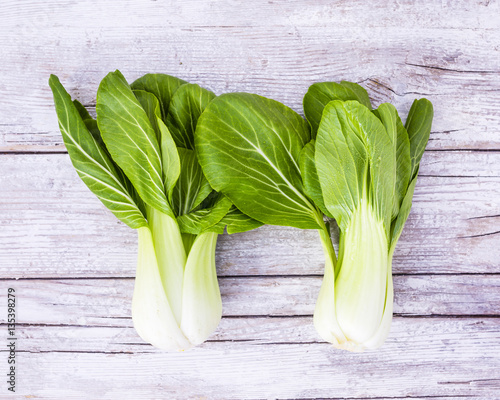 Fresh and raw Chinese cabbage pak choi on wooden background. 