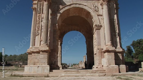 Tilt down the Arch of Septimius Severus in Leptis Magna the extensive Roman ruins near Al Homs, Libya photo