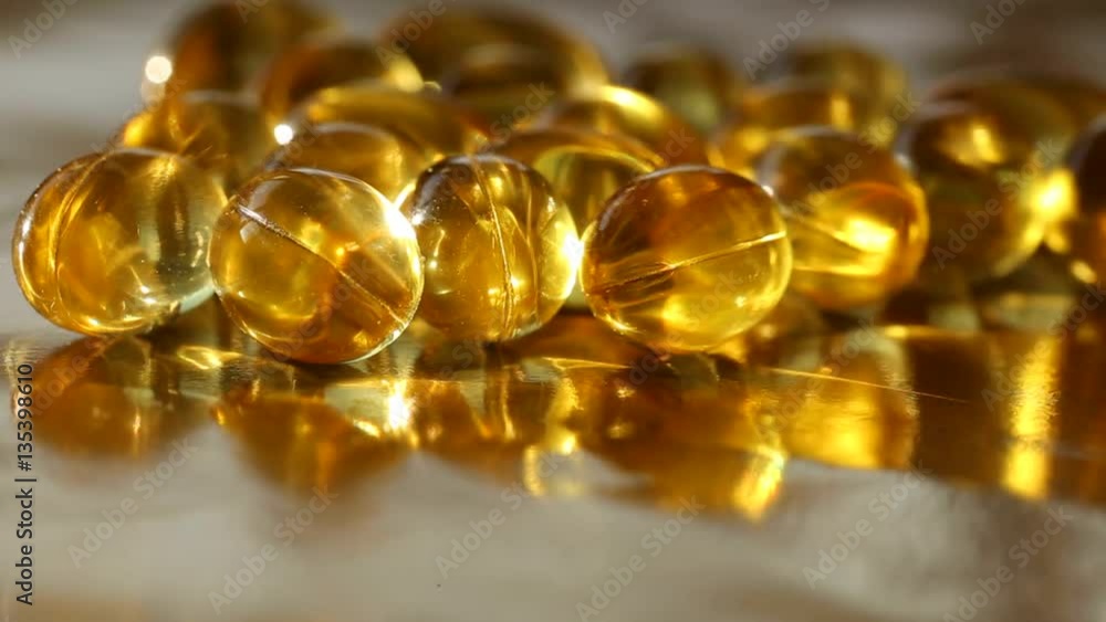 gelatin oil capsules on a gold background gelatin oil capsules on a gold background