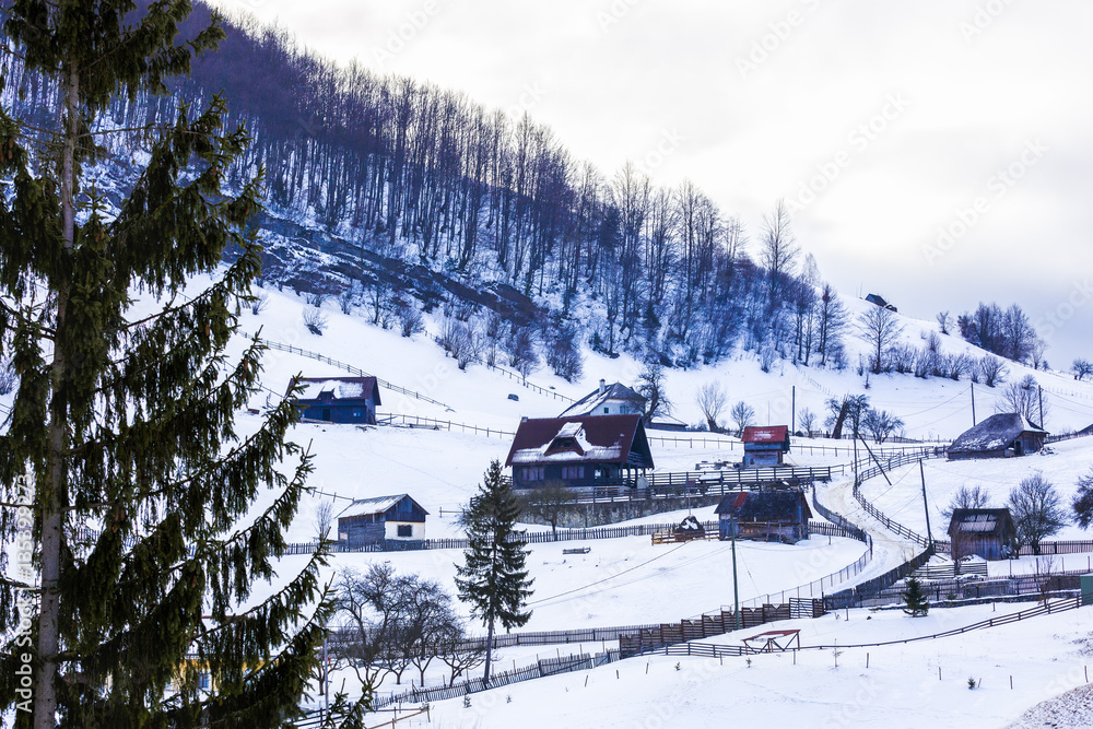 Obraz premium winter landscape with a mountain village in Romania