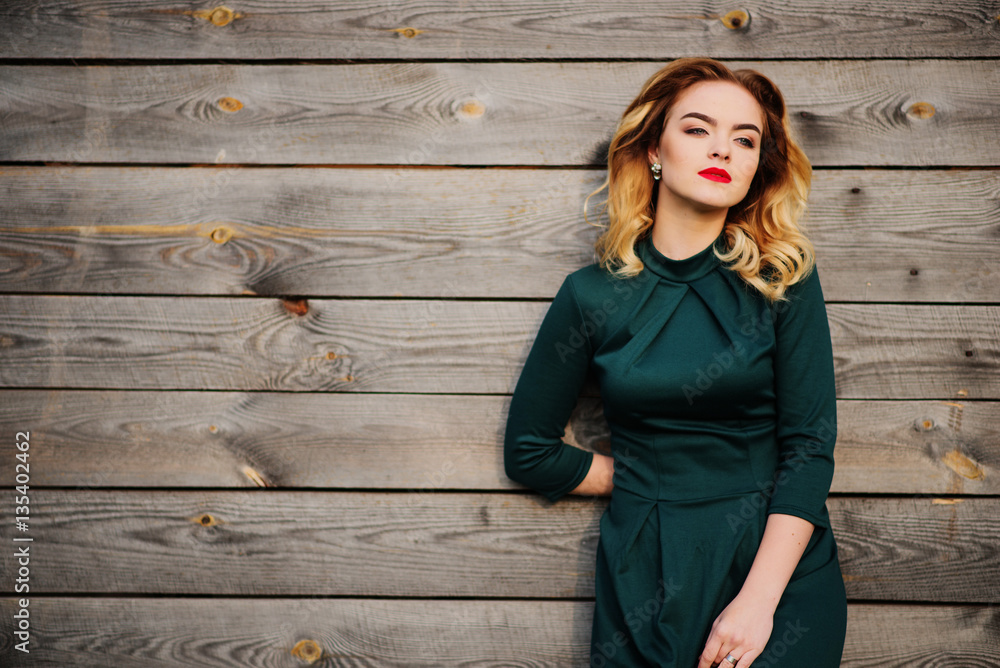 Yong elegance blonde girl at green dress background wooden textu Stock ...