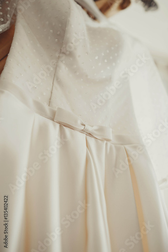 details of beautiful white and gentle wedding dress © myronovychoksana