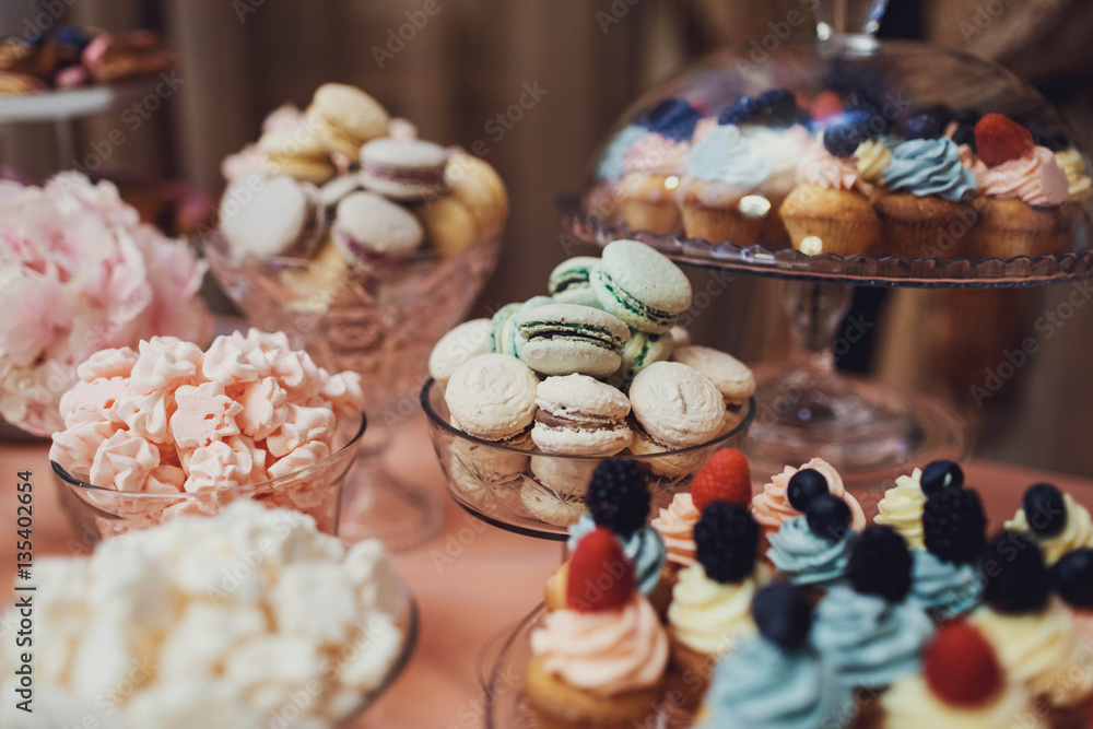 delicious colorful cookies and cakes on the wedding candy bar
