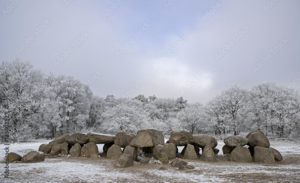 Dolmen Netherlands in winter. Snow and frost. . Megalithic tombstone
