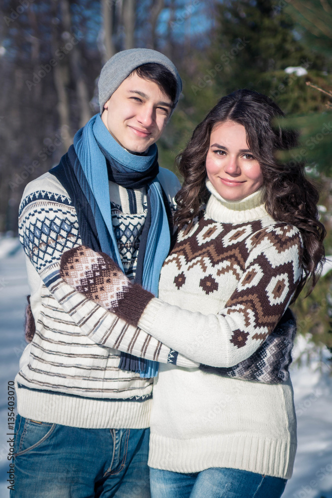 Couple in love hugs in winter park