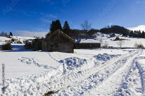 Old wooden house in winter landscape, Romania © czamfir