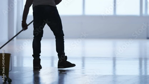 Man Cleaning the Floor in a Gym