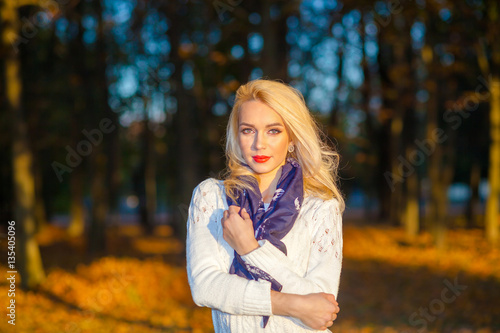 beautiful blonde girl in a white sweater freezing in the park © ruslimonchyk