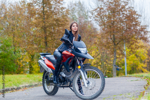 Portrait of a beautiful hipster girl on a sports motorcycle