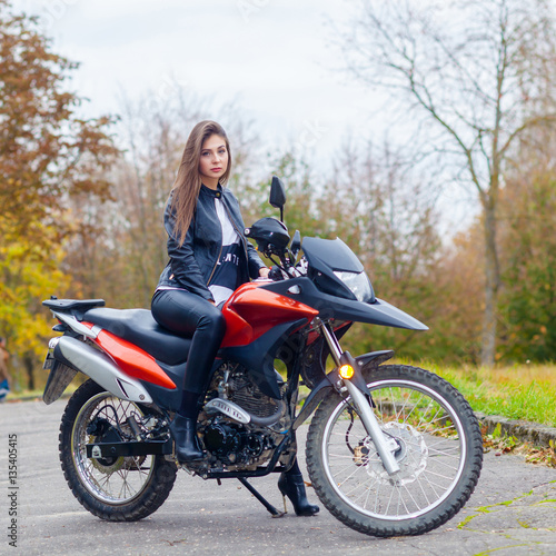 Portrait of a beautiful hipster girl on a sports motorcycle © ruslimonchyk