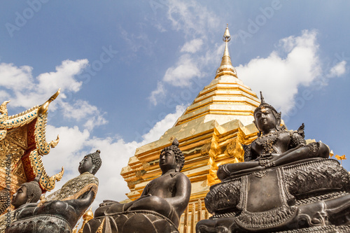 On the way to the sky  spiritual elevation and ascension  golden buddhist pagoda with buddha statues  Doi Suthep  Chiang Mai  Thailand 