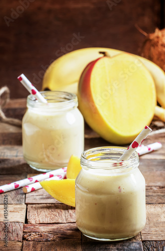 Smoothie with banana, cream and mango, rustic style, selective f