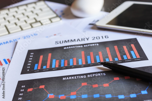 Wallpaper Mural showing business   financial and accounting report on wooden table in office  with warm fall colors. soft-focus in the background. over light Torontodigital.ca