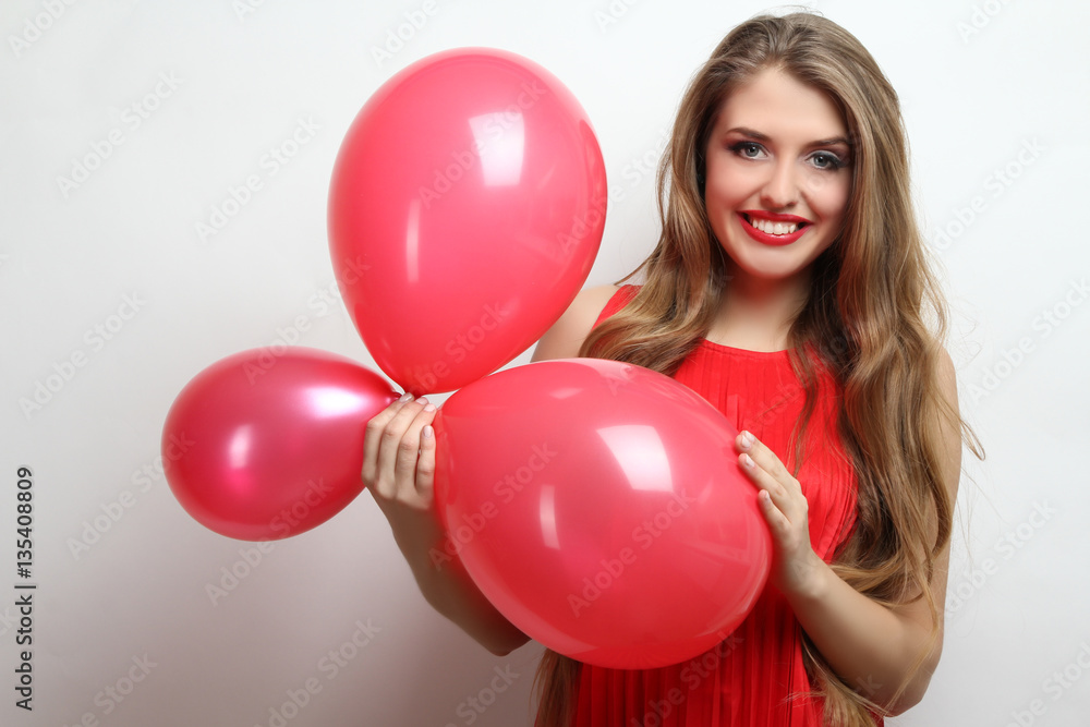 Cheerful girl holding balloons in hands. Cheerful girl holding balloons in hands.