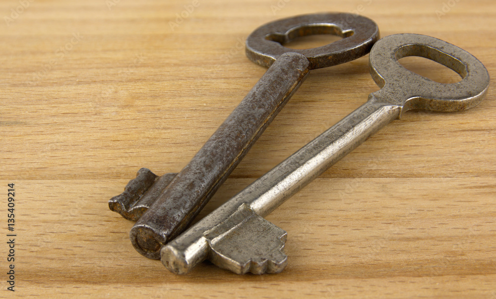 Old keys on a wooden board Old keys on a wooden board