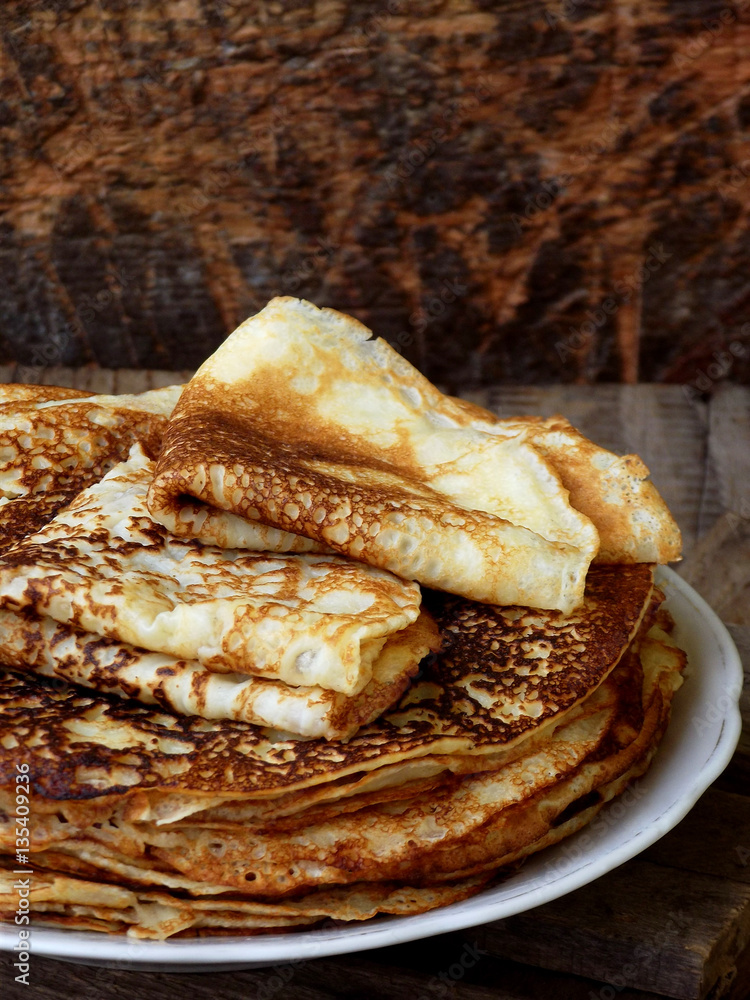 Fried crepes on the plate. Russian pancakes. View from side. Selective focus Fried crepes on the plate. Russian pancakes. View from side. Selective focus