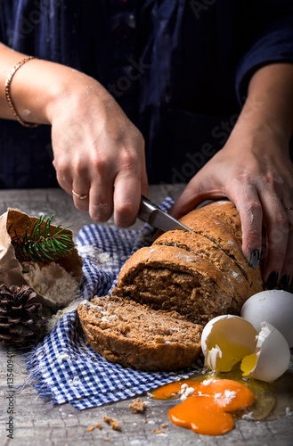 Female hands slicing homemade bread