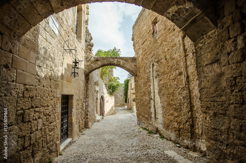 Fototapeta Naklejka Na Ścianę i Meble -  Medieval arched street in the old town of Rhodes, Greece