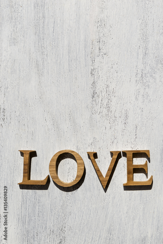 Wooden love on white wood background, outdoor day light Wooden love on white wood background, outdoor day light