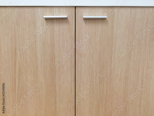 Closeup wooden cabinet / cupboard doors with handles for background