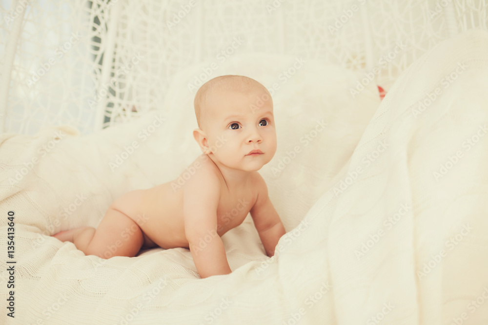 portrait of a cute baby sitting on a bed portrait of a cute baby sitting on a bed