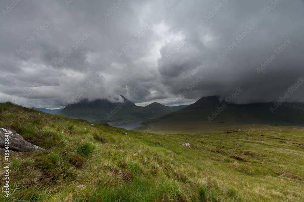 On the top of Stac Pollaidh with splendid view over loch and mountains On the top of Stac Pollaidh with splendid view over loch and mountains