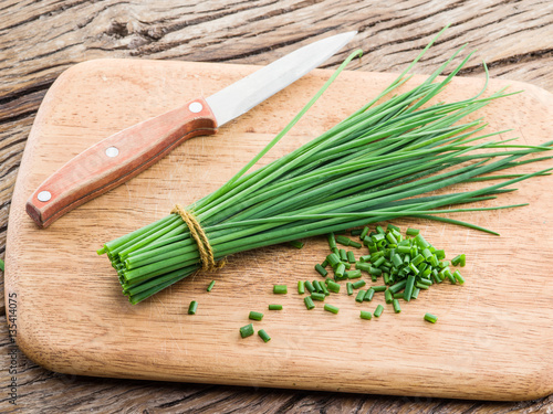 Green onion on the wooden table.