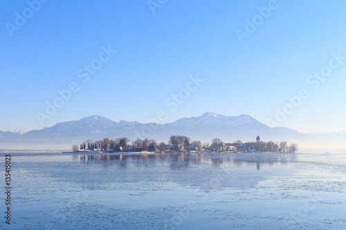 Island Fraueninsel on partly frozen Lake Chiemsee in Bavaria, Germany, on a cold winter day